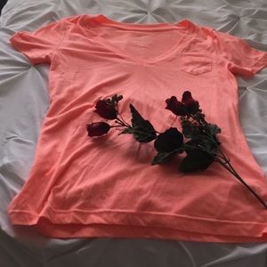 Coral short sleeve shirt with one pocket.